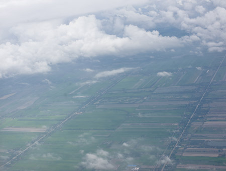 the bird eye view angle when look out the window of plane on skyの写真素材