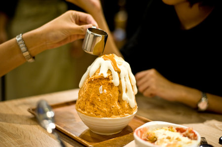 the girl use spoon to eat sweet in white disk look deliciousの写真素材