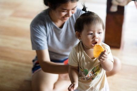 Udornthani, Thailand - July 8 : The portrait of daughter playing with mother in home look like the happy of family on the July 8, 2017 in Udornthani, Thailandのeditorial素材