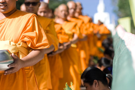 Khon Kaen, Thailand - Oct 28 : Tak Bat Devo Rohana is the Festival of buddhism for give food offerings to a Buddhist monk in the End of Buddhist Lent Day on the Oct 28, 2015 in Ubolratana District, Khon Kaen, Thailand.のeditorial素材