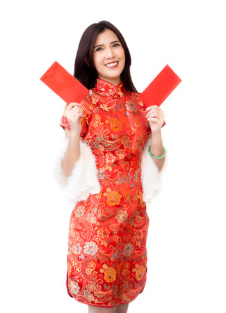 Chinese new year woman concept, isolated asian woman wearing red dress Cheongsam holding money gift.の写真素材