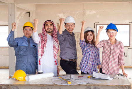Engineer, architect and arab businessman planing for project construction building, talking and discuss on drawing blueprint plan, working with happy feelingの写真素材