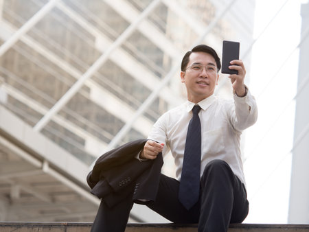 Portrait middle aged asian businessman in the city, businessman, manager, boss handsome looking in the city concept.の写真素材