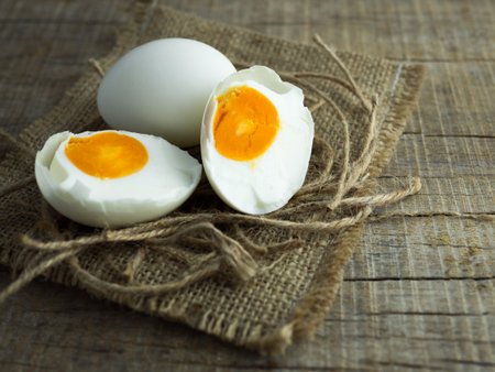 Duck eggs, white eggs, salted eggs with yolk on old sack and ropes with wooden background.の写真素材