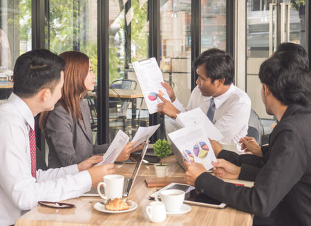 Meetings business young and smiling man/woman, discussing for financial report at meeting for business achievement and successの写真素材
