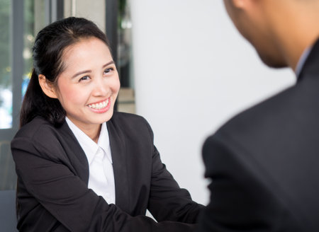 Young beautiful asian businesswoman in modern office, discussing during interview with manager in meeting roomの写真素材