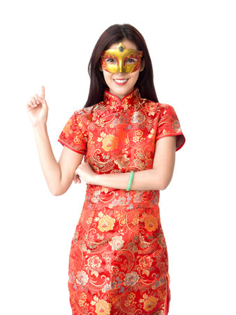 Chinese new year woman concept, isolated asian woman wearing red dress with finger pointing actingの写真素材