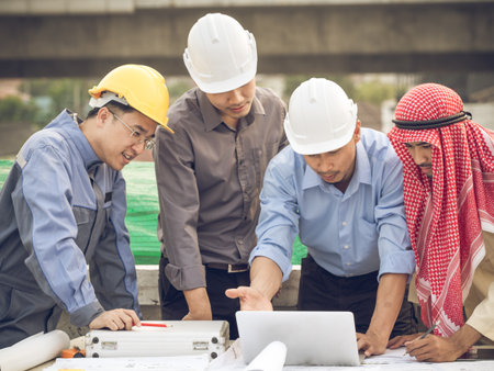 Engineer, architect and arab businessman planing for project construction building, talking and discuss on drawing blueprint plan, working with happy feelingの写真素材