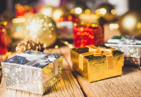 Christmas present box with golden ball and pine cone with decoration for christmas dayの写真素材