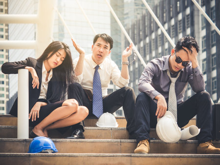 Upset businessman/engineer/businesswoman unemployed man, sitting at stair when fired from work, negative, feeling down, disappointed conceptの写真素材