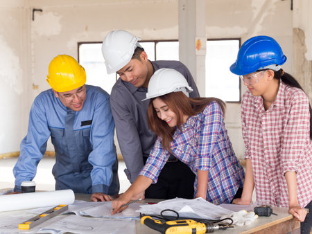 Engineer, architect and arab businessman planing for project construction building, talking and discuss on drawing blueprint plan, working with happy feelingの写真素材