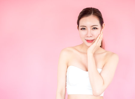 Beautiful asian woman on pink background, make up, healthy skin, beauty, cute asian woman conceptの写真素材