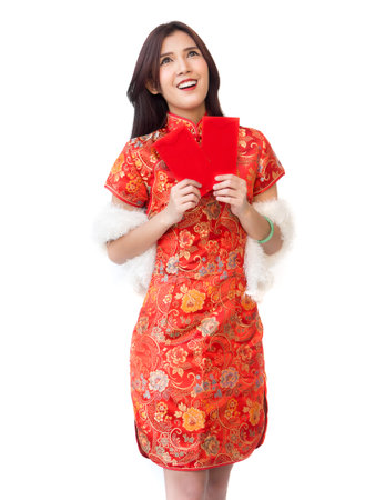 Chinese new year woman concept, isolated asian woman wearing red dress Cheongsam holding money gift surprise feelingの写真素材