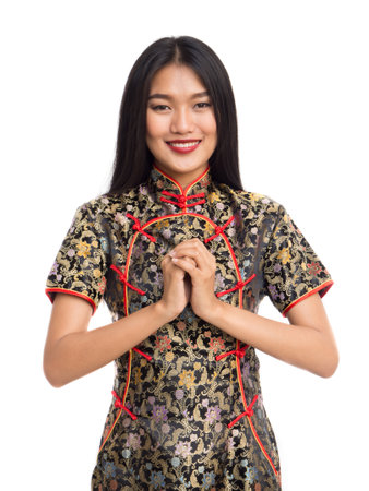 Chinese new year woman concept, isolated asian woman wearing red dress welcome actingの写真素材