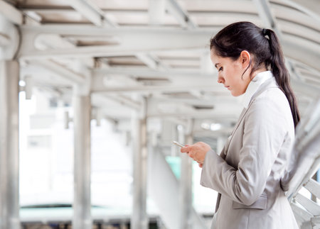Portrait young Caucasian businesswoman, smart employee, wear suit and using smart phoneの写真素材
