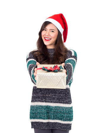 Young happy asian woman with santa hat holding gift box present for christmas party and celebration isolated on white background, merry christmas and happy new year conceptの写真素材