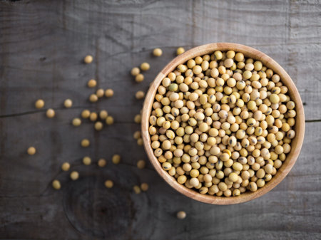 Soy beans in a wooden bowl on wooden backgroundの写真素材