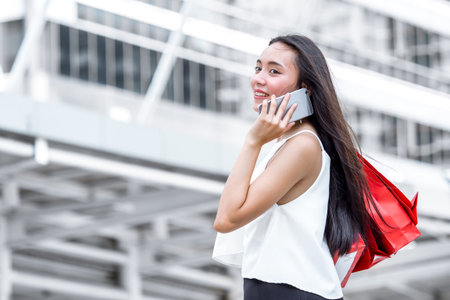 Close up woman holding shopping bag with colorful walking in the city with copy spaceの写真素材
