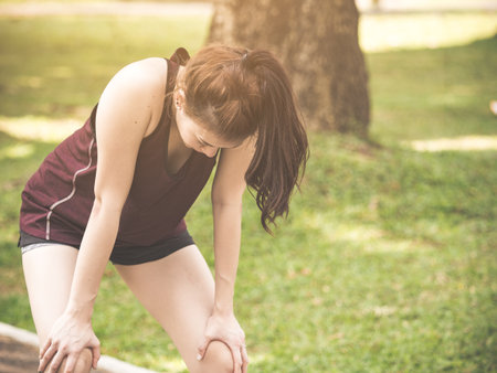 Beautiful young asian woman exhausted from workout running jogging fitness outdoor, tied, thirsty feeling, sport woman fitness outdoor conceptの写真素材