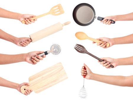 Chef's hands holding kitchen utensils/many equipments for food isolated on white backgroundの写真素材