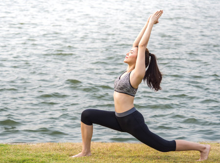 Woman fitness outdoor concept, young woman stretching for sport workout, yoga, running at park in the morning, fresh, relax and happy feelingの写真素材
