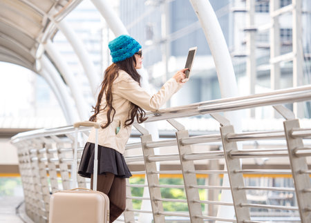 Woman traveler with bag, luggage, suitcase arrival at the airport during travelの写真素材