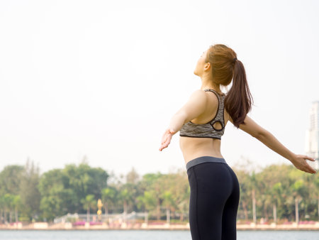 Woman fitness outdoor concept, young asian beautiful woman/sport girl running walking and yoga at outdoor park with fresh, relax, happy feeling.の写真素材