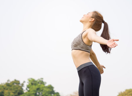 Woman fitness outdoor concept, young asian beautiful woman/sport girl running walking and yoga at outdoor park with fresh, relax, happy feeling.の写真素材