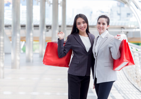Close up woman holding shopping bag with colorful walking in the city with copy spaceの写真素材