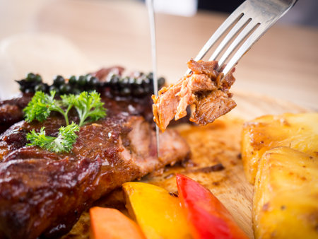 Close up sliced grilled steak pork / beef on forkの写真素材
