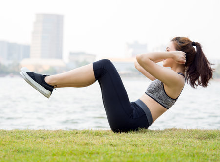 Woman workout outdoor concept, young asian beautiful woman/sport girl running walking and yoga at outdoor park with fresh, relax, happy feeling.の写真素材