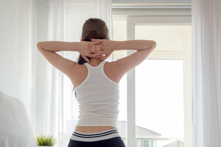 Young asian woman wake up happy, stretching and feeling fresh in the morningの写真素材