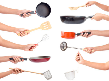 Chef's hands holding kitchen utensils/many equipments for food isolated on white backgroundの写真素材