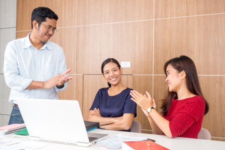 Meetings business young and smiling man/woman, clapping for celebration meeting for business achievement and successの写真素材