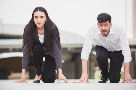 Young businessman and businesswoman sitting in starting point, ready to work, start up business,...
