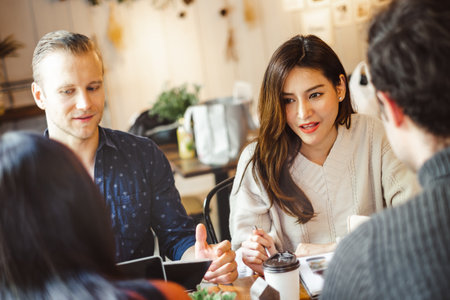 Group of young business people discussing and meeting at coffee cafe