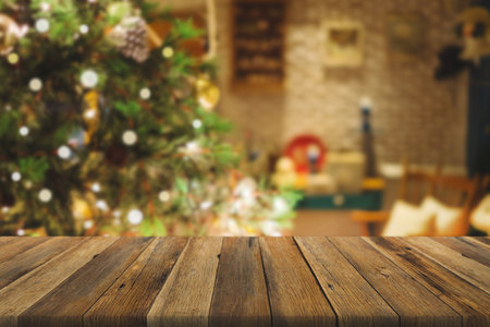 Wood table over Christmas tree with decoration blur background. can be used for display or montage products.の写真素材