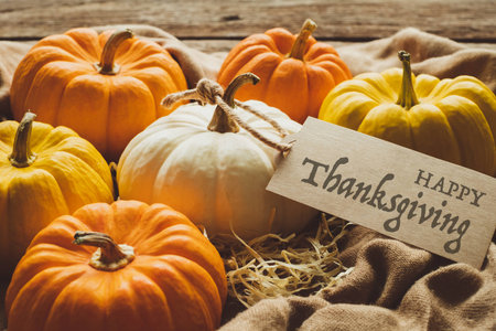 Thanksgiving background, pumpkin with tag, leaves and decoration on wood table background with copy space. flatlayの写真素材
