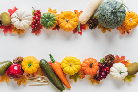 Thanksgiving background, pumpkin fruits vegetable, leaves and decoration on white background with copy space. flatlayの写真素材