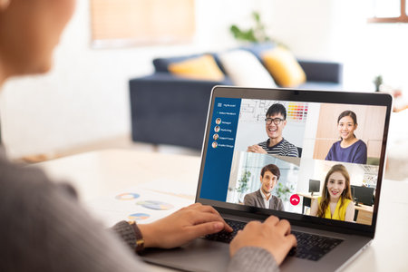 Young Asian businesswoman work at home and virtual video conference meeting with colleagues business people, online working, video call due to social distancingの写真素材