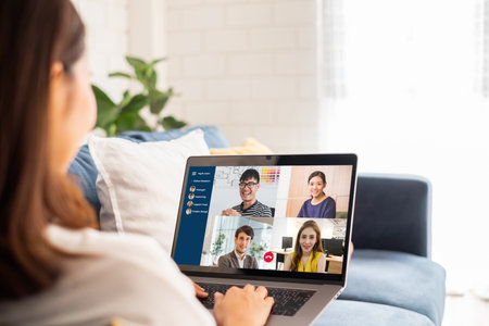 Young Asian businesswoman work at home and virtual video conference meeting with colleagues business people, online working, video call due to social distancingの写真素材