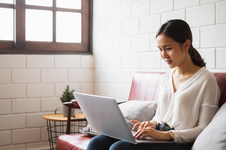 Work from home or work at home concept, asian woman working with laptop computer at homeの写真素材