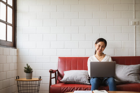 Work from home or work at home concept, asian woman working with laptop computer at homeの写真素材