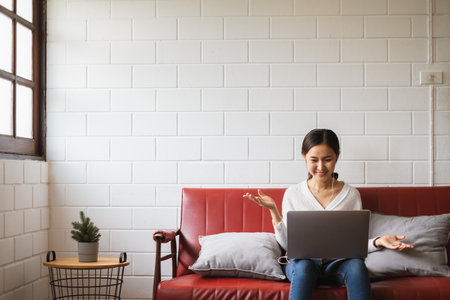 Work from home or work at home concept, asian woman working with laptop computer at homeの写真素材
