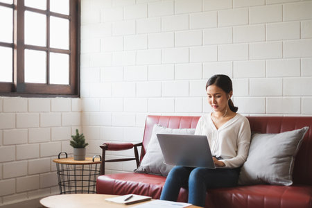 Work from home or work at home concept, asian woman working with laptop computer at homeの写真素材