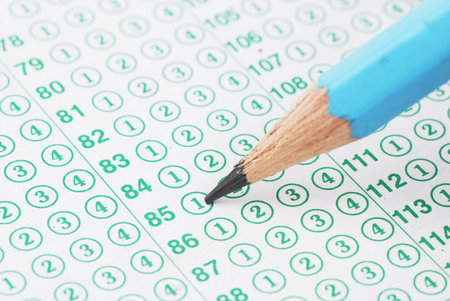 Pencils on blank test sheet close up