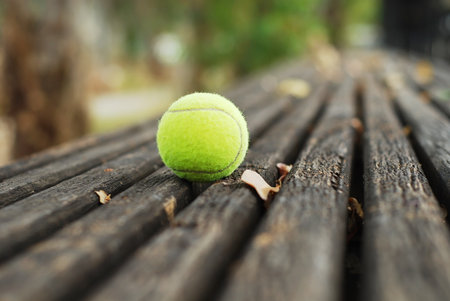 Tennis ball on wood floorの写真素材