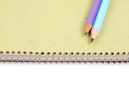 Pencils on green notebooksの写真素材