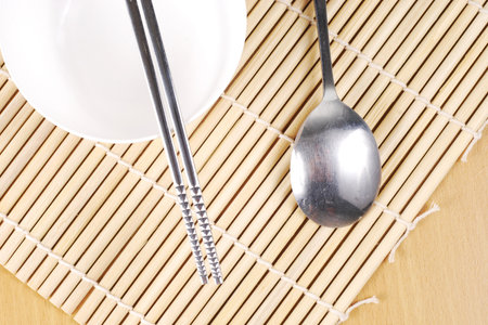 asian dish place setting on bamboo matの写真素材