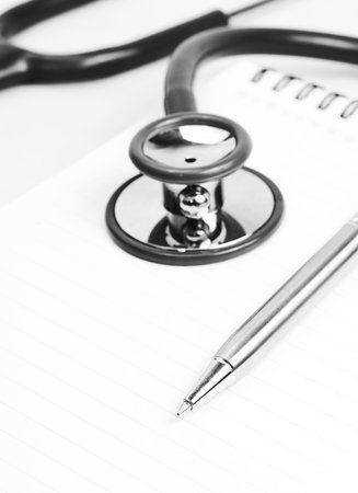 silver pen and stethoscope on meadical notebookの写真素材